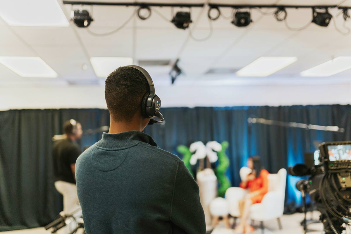 Ηχολήπτης σε παραγωγή εταιρικού βίντεο τεστάρει την ηχητική του χώορυ της βιντεολήψης